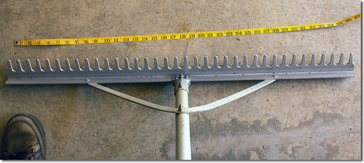 The aluminum rake used for leveling the gravel before the design is made. The rakehead is approximately 36 inches (92 centimeters).