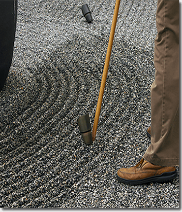 ridge_detail Using the broom handle to complete grooves around an in-ground spotlight at the Harn. Using the broom handle to complete grooves around an in-ground spotlight at the Harn.