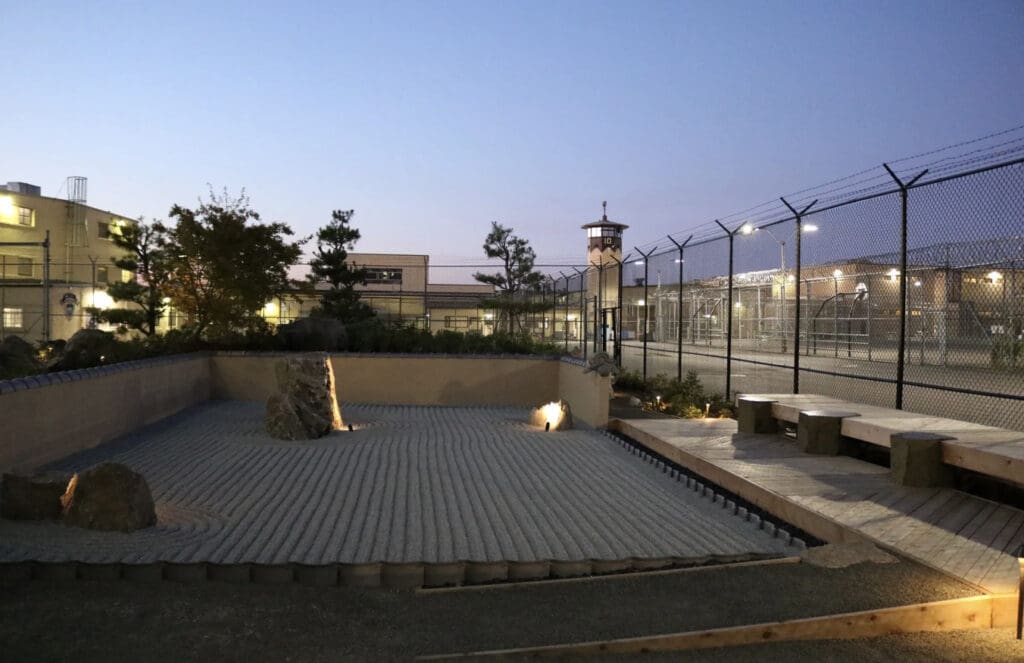 Raked sand in a prison courtyard garden